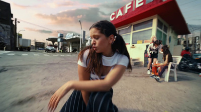 a woman squatting down in front of a cafe