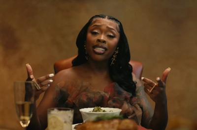 a woman sitting at a table with a plate of food