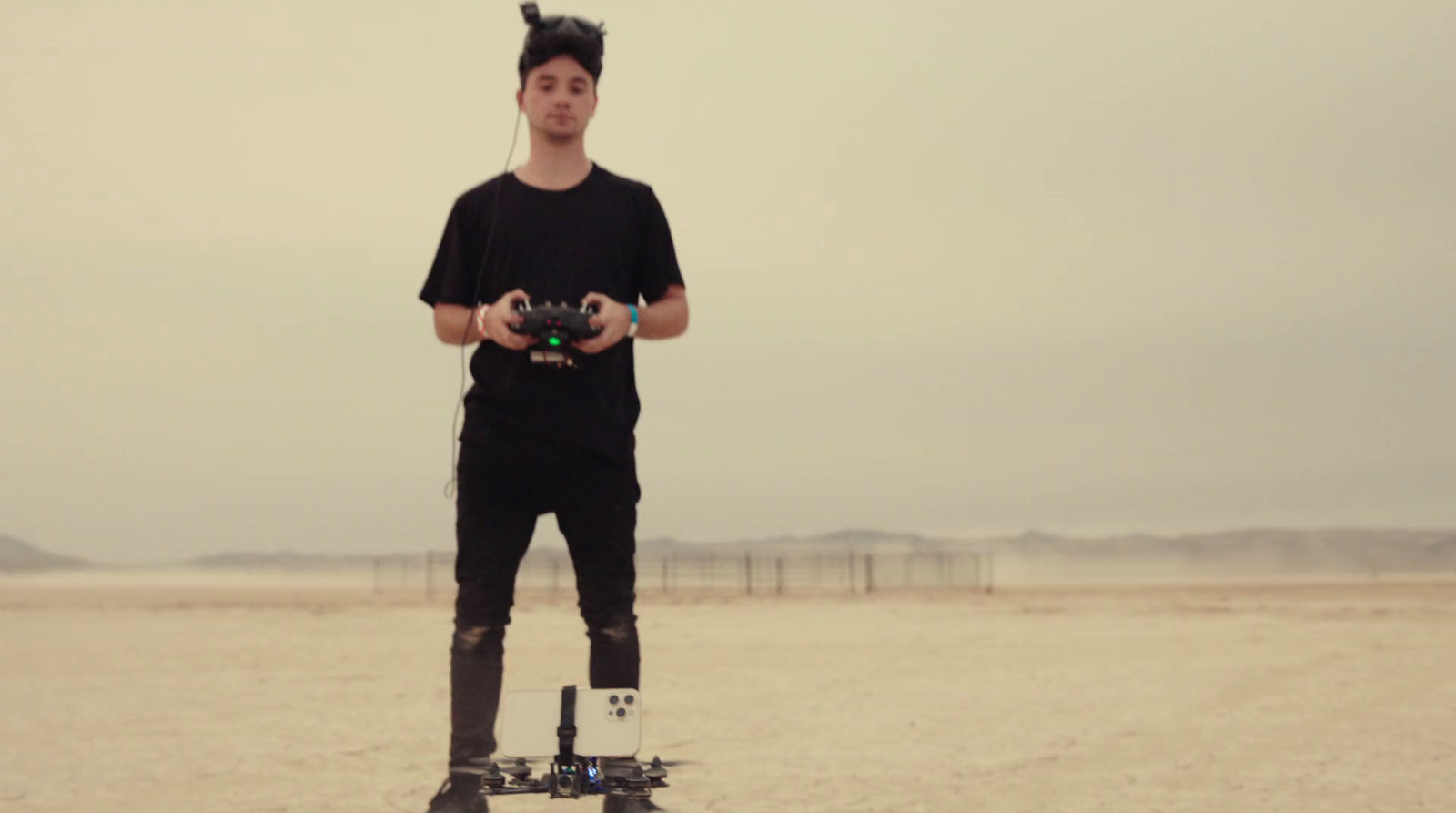 a man standing on top of a skateboard in the desert