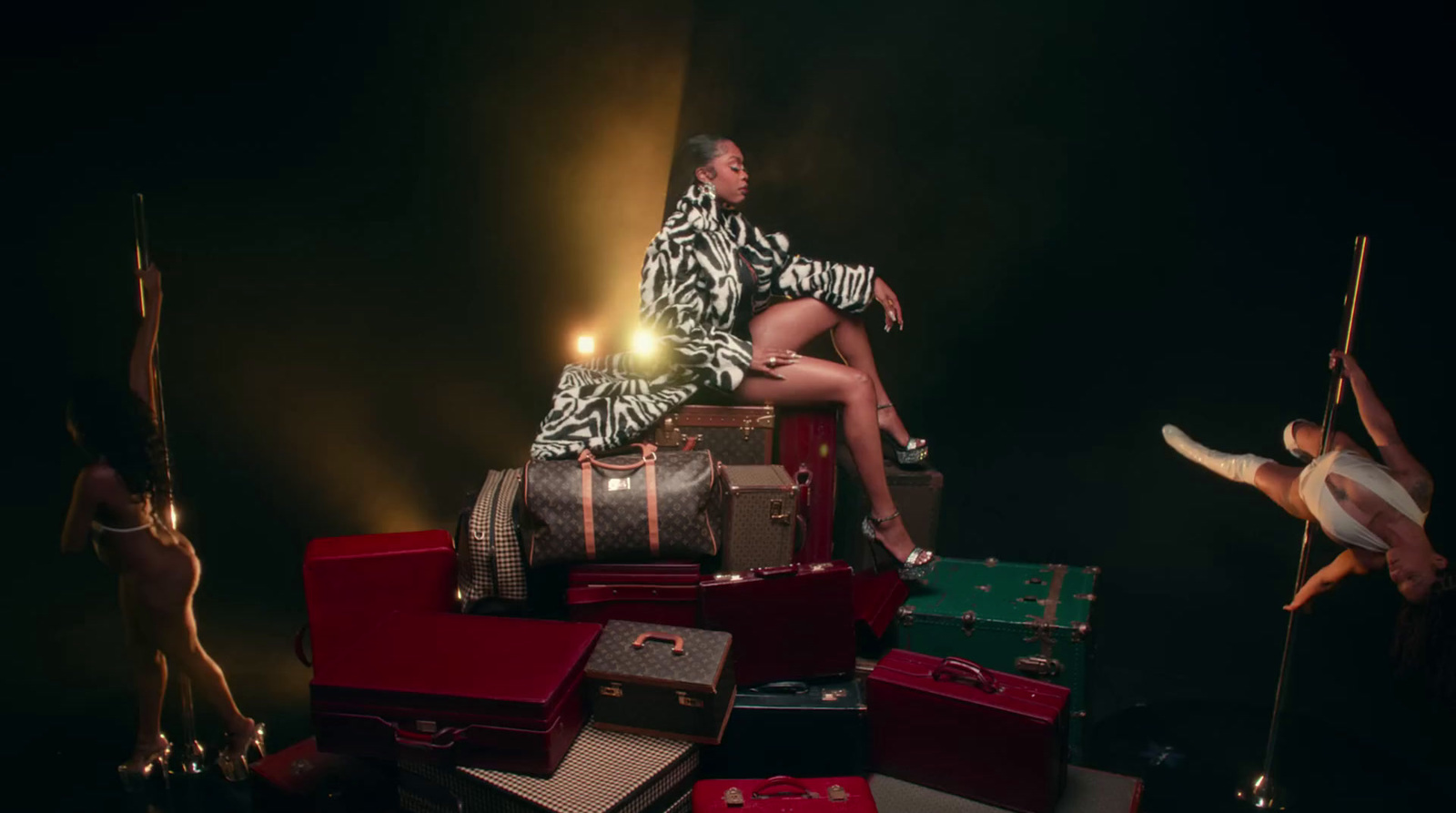 a woman sitting on top of a pile of luggage