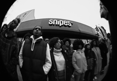 a group of people standing in front of a store