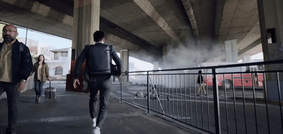 a group of people walking down a street next to a bridge