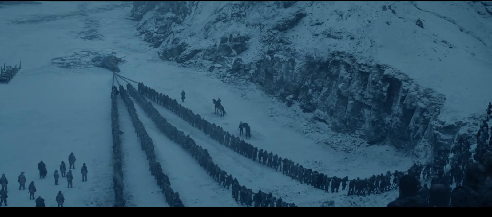 a group of people standing on top of a snow covered hillside