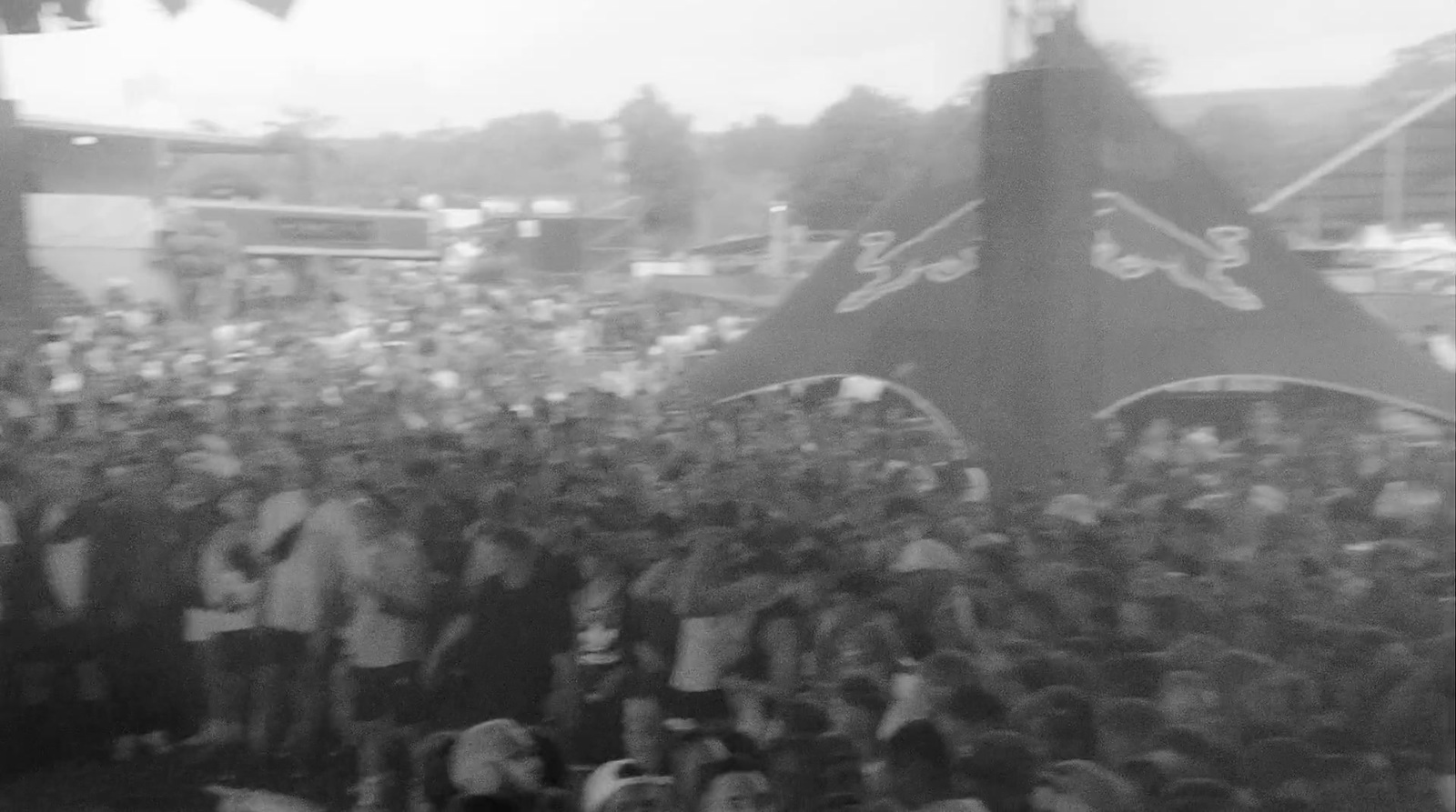 a large crowd of people standing around a stage