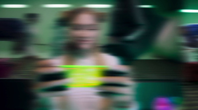 a blurry photo of a woman holding a cell phone