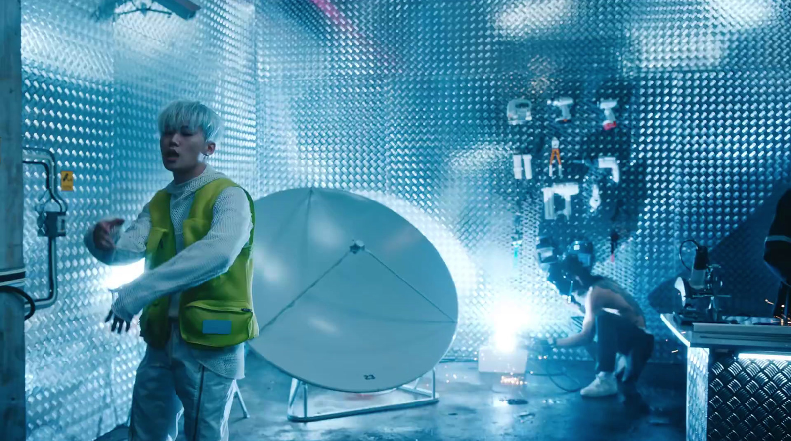 a man standing in front of a satellite dish