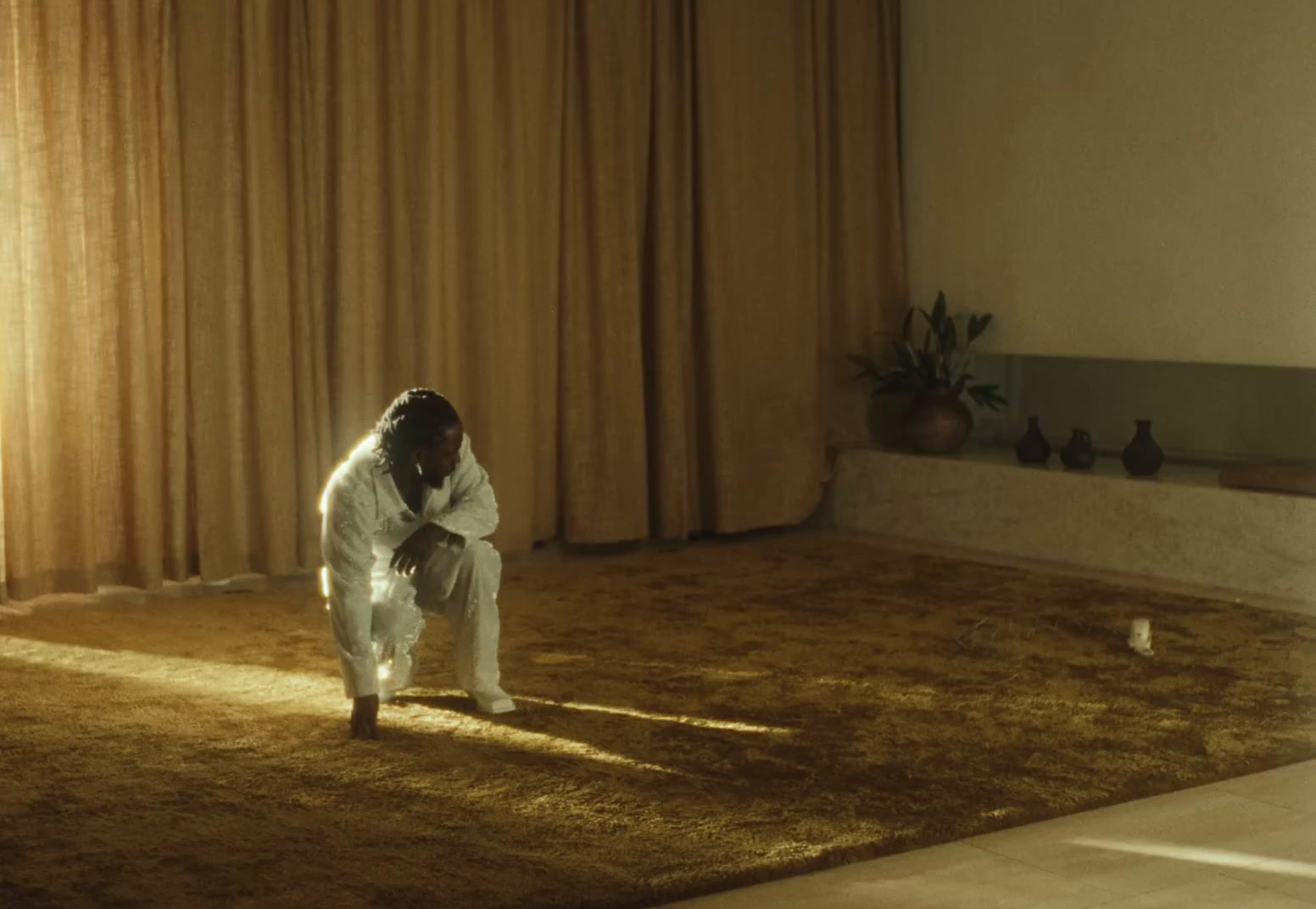 a person kneeling on a rug in a living room