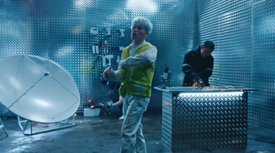 a man standing in front of a satellite dish