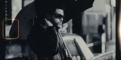 a black and white photo of a man holding an umbrella