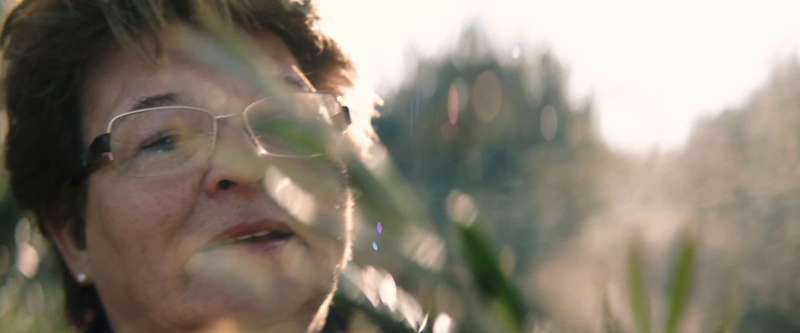 a woman wearing glasses looking up at the sky