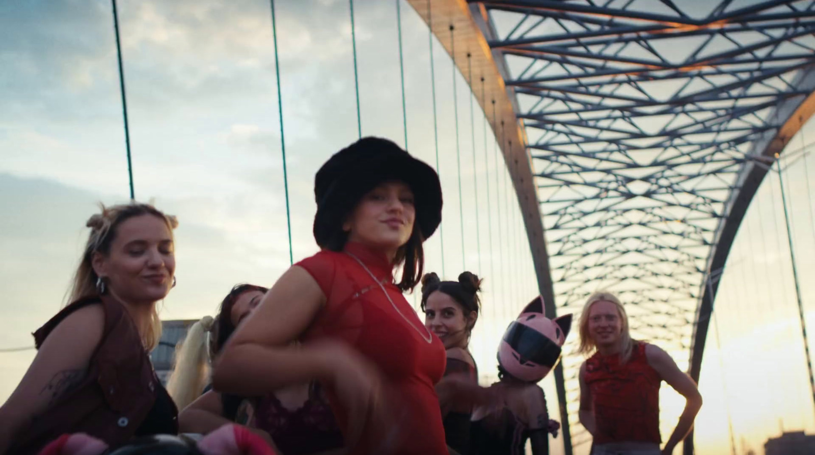 a group of women standing on top of a bridge