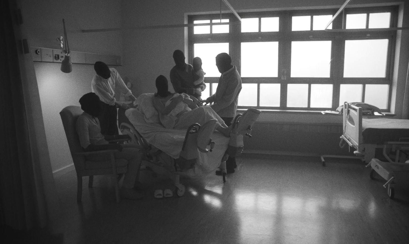 a group of people in a hospital room