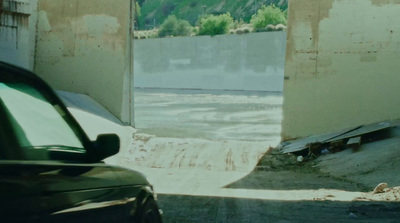 a car parked in front of a building under construction