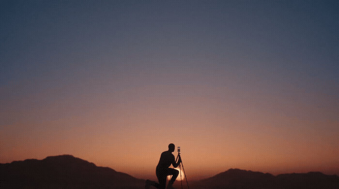 a man standing on top of a snow covered slope