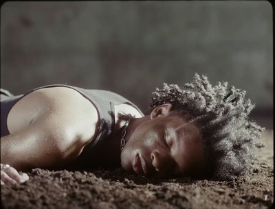 a person laying on the ground with their eyes closed