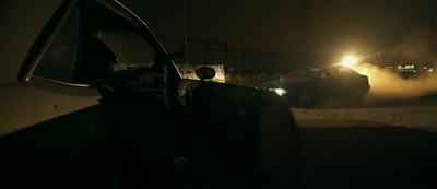 a car driving down a street at night