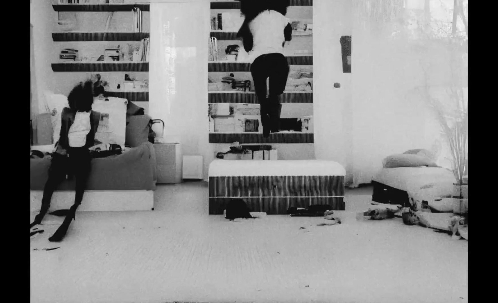 a woman standing on top of a ladder in a living room