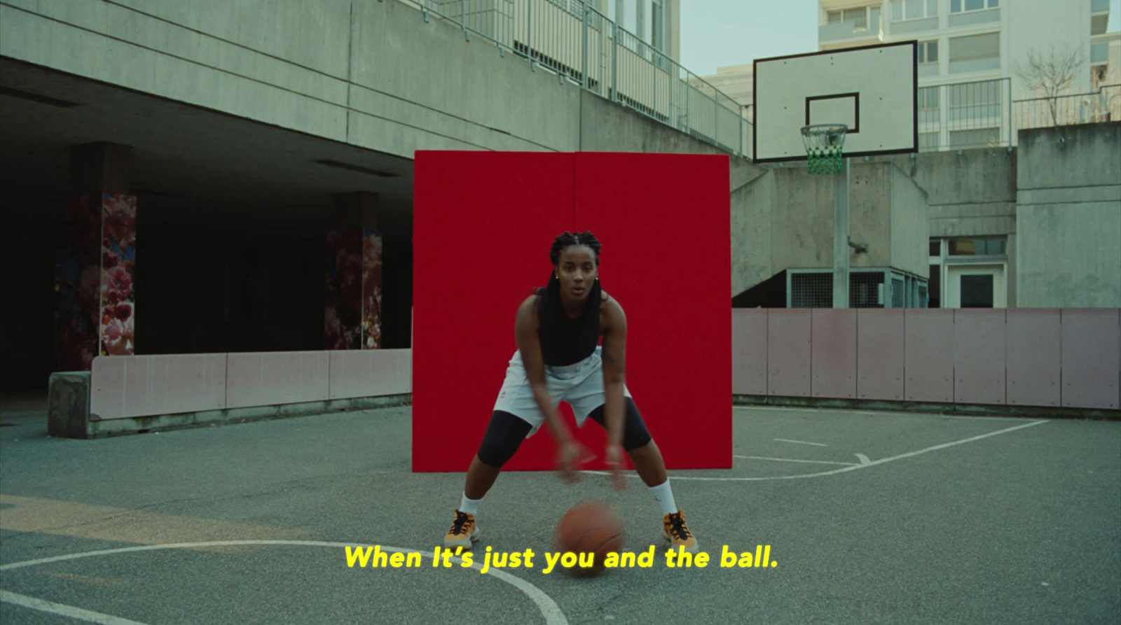 a woman is playing basketball on a basketball court