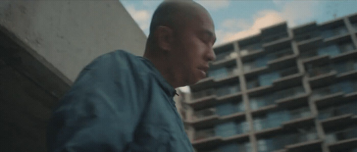 a man standing in front of a tall building