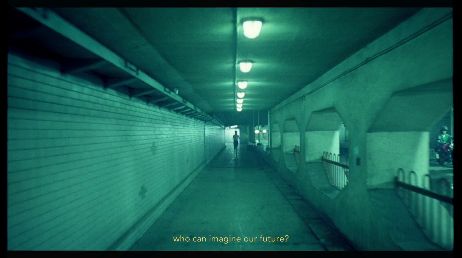 a person walking down a long hallway in a building