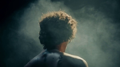 the back of a woman's head in smoke