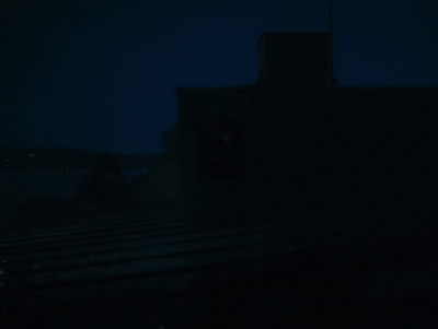 a dark picture of a building at night