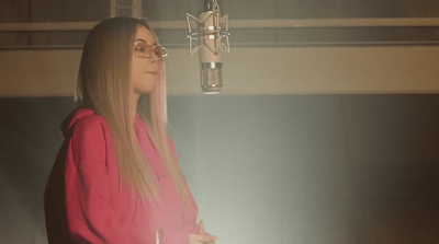 a woman standing in front of a microphone