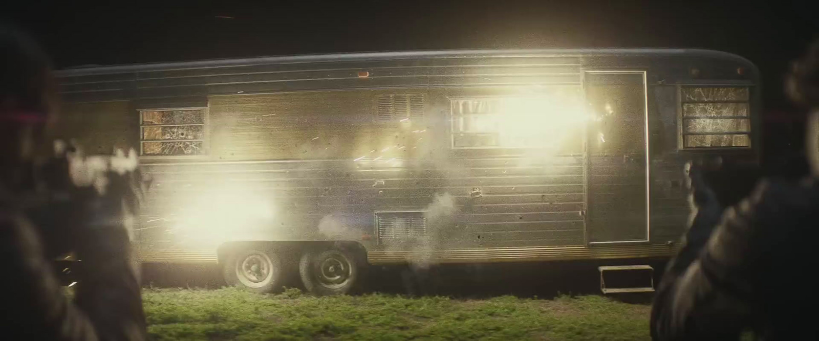 a person standing in front of a trailer at night