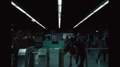 a group of people walking through a subway station