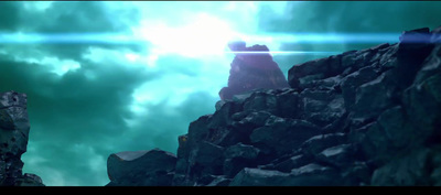 a man standing on top of a rocky mountain under a cloudy sky