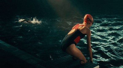 a woman in a red and black bathing suit in the water