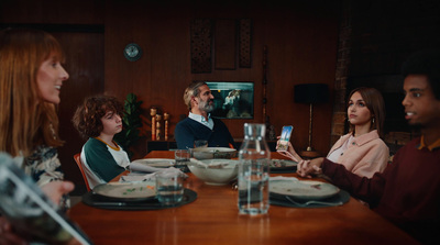 a group of people sitting around a wooden table