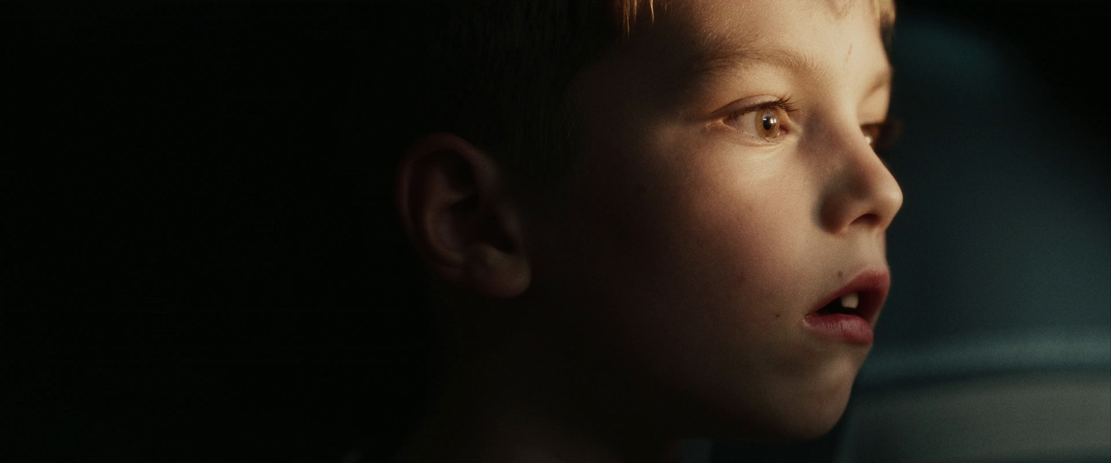 a young boy with a surprised look on his face