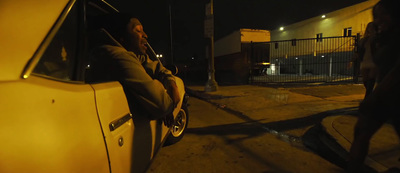 a man leaning out of a car window at night