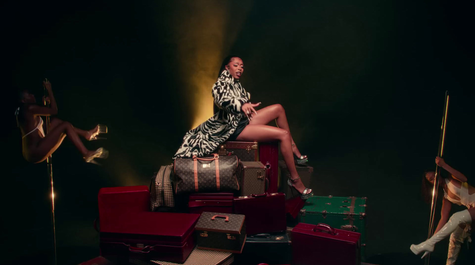 a woman sitting on top of a pile of luggage