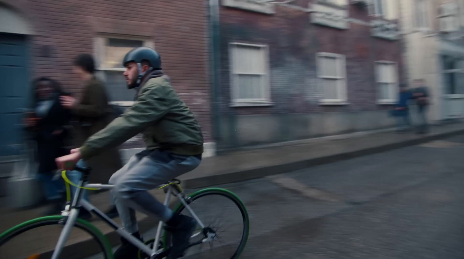 a man riding a bike down a street