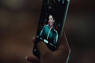 a person holding a cell phone with a picture of a woman on it