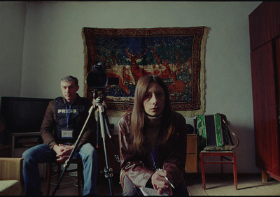 a man and a woman sitting in front of a camera