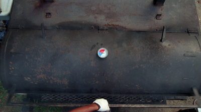 a close up of a grill with a red, white and blue button on it