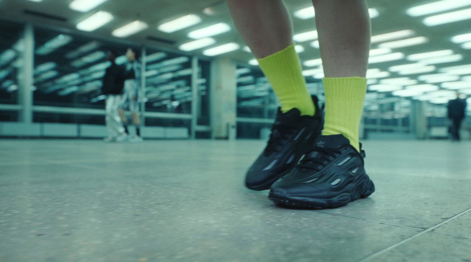 a pair of feet in black and yellow socks