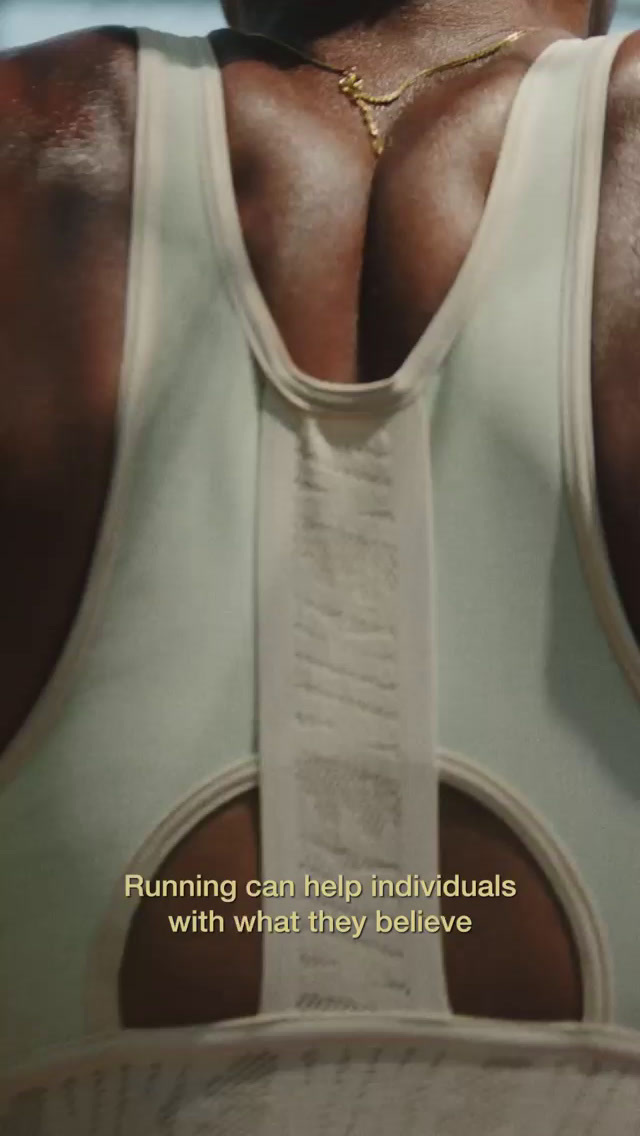 a man in a sports bra with a quote on his back