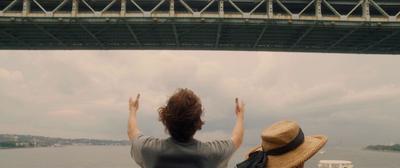 a couple of people that are standing in front of a bridge