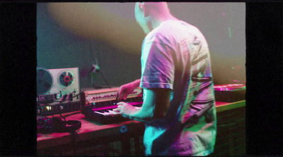 a man standing in front of a mixing desk