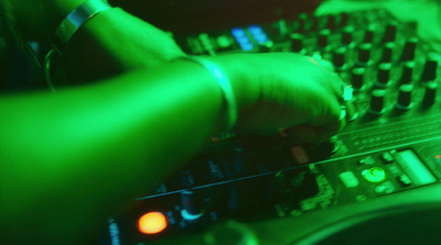 a close up of a dj's hands on a keyboard