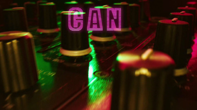 a close up of a dj equipment with a neon sign in the background