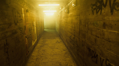 a long narrow hallway with graffiti on the walls