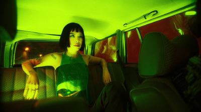 a woman sitting in the back seat of a car