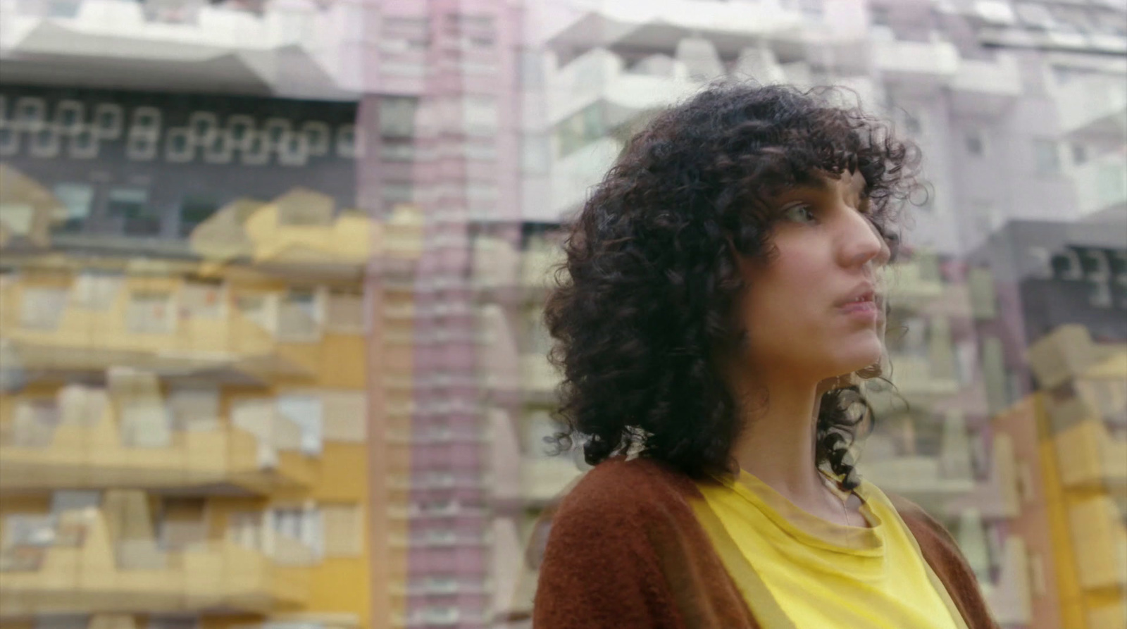 a woman standing in front of a tall building