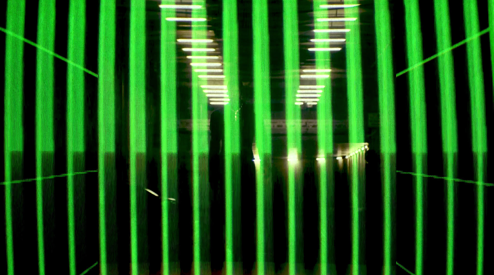 a blurry photo of a building with green bars