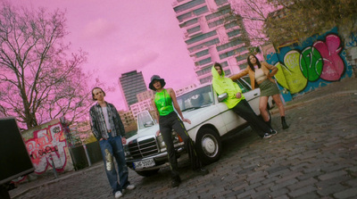 a group of women standing next to a white car